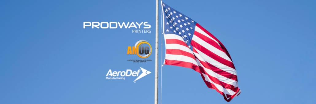 Prodways Printers logo alongside AMUG and AeroDef Manufacturing logos next to a waving American flag against a clear blue sky
