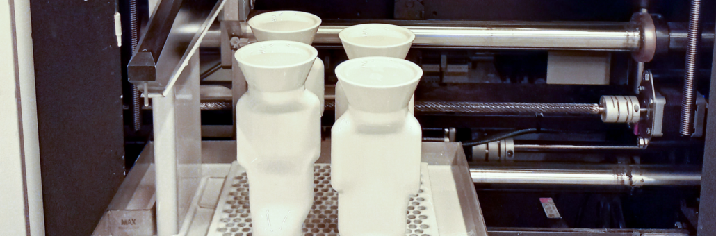 Prodways industrial 3D printer manufacturing white ceramic or plastic parts during a webinar demonstration.